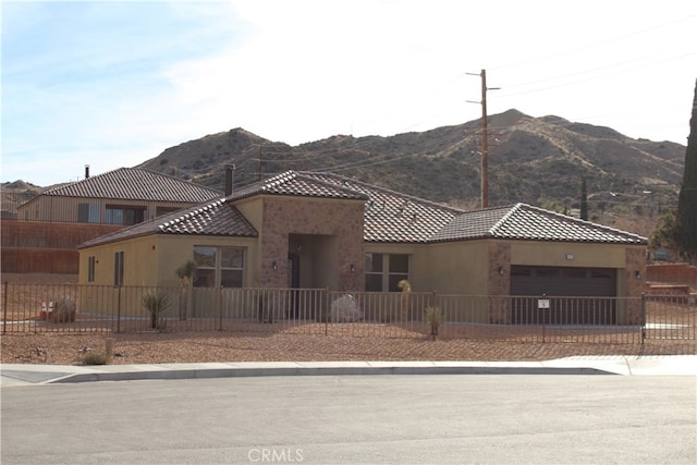 view of front of house with a mountain view and a garage