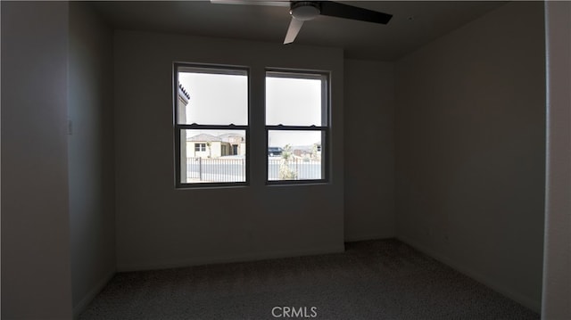 unfurnished room featuring ceiling fan and carpet flooring