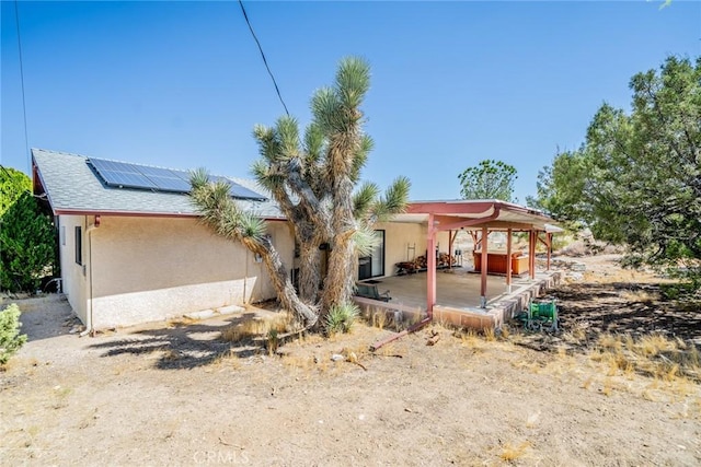 exterior space with a patio area and solar panels