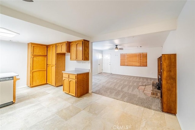 kitchen with ceiling fan, light colored carpet, and stainless steel dishwasher