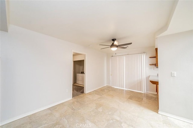 unfurnished room featuring ceiling fan and washer / clothes dryer