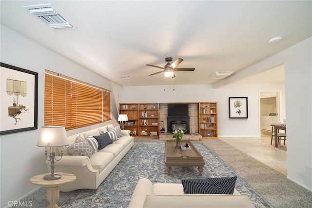 living room featuring carpet, ceiling fan, and a brick fireplace