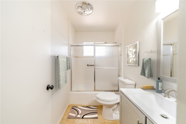 full bathroom featuring tile patterned flooring, vanity, toilet, and bath / shower combo with glass door