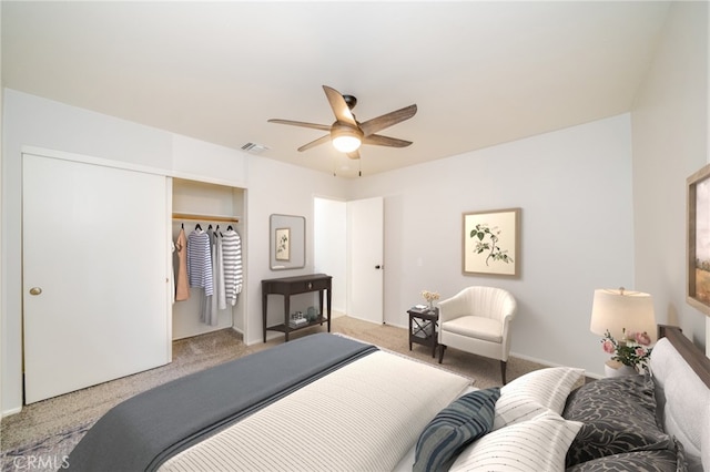 carpeted bedroom with a closet and ceiling fan