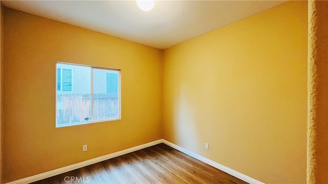 empty room with wood-type flooring