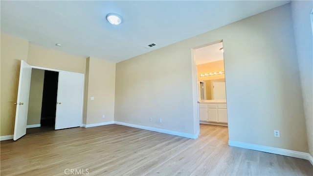 spare room with light hardwood / wood-style floors