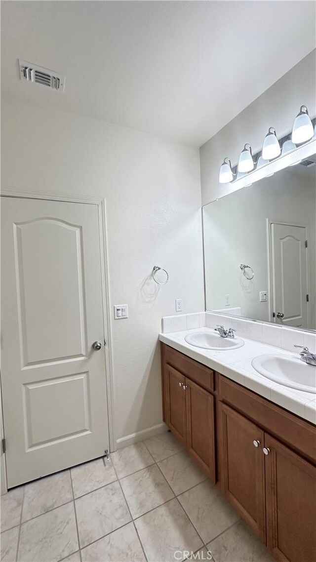 bathroom featuring vanity and tile patterned flooring