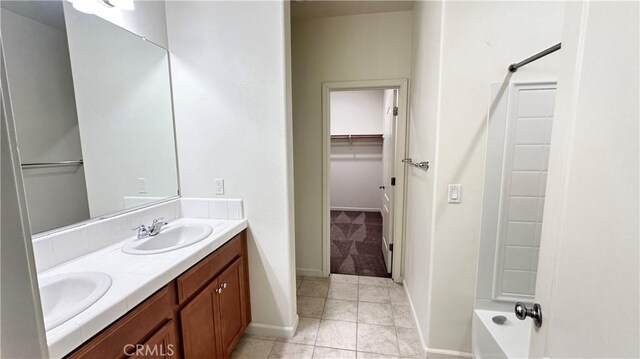 bathroom featuring a tub to relax in, tile patterned floors, and vanity