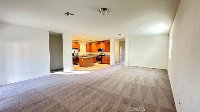 unfurnished living room featuring light colored carpet