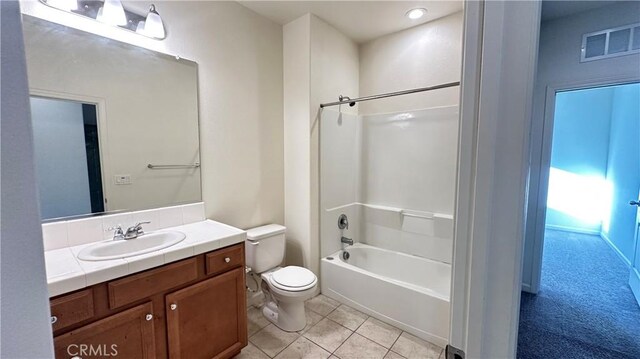 full bathroom with tile patterned flooring, vanity, tub / shower combination, and toilet