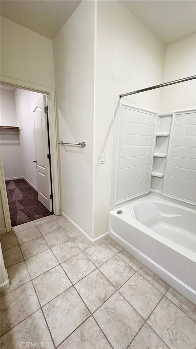 bathroom featuring bathing tub / shower combination and tile patterned flooring