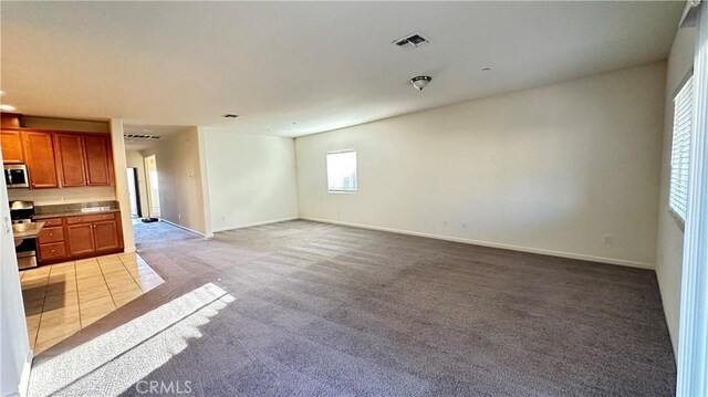 unfurnished living room featuring light carpet