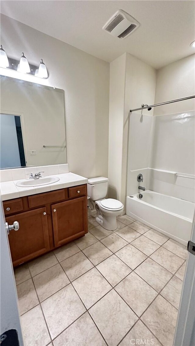 full bathroom with tile patterned floors, toilet, shower / washtub combination, and vanity