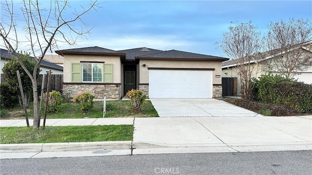 view of front of house with stucco siding, stone siding, a garage, and concrete driveway