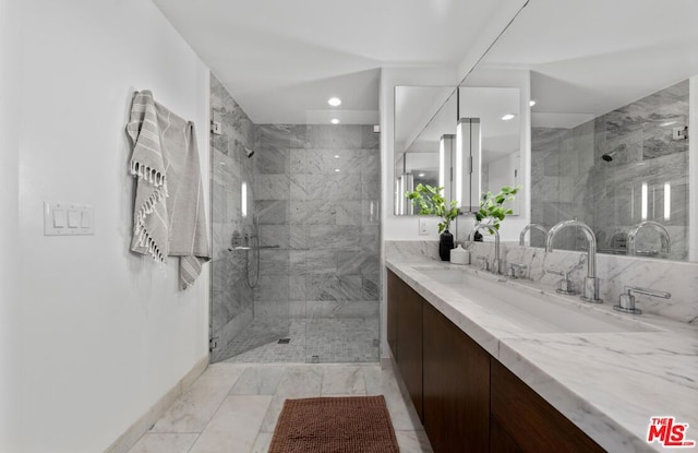 bathroom featuring a tile shower and vanity