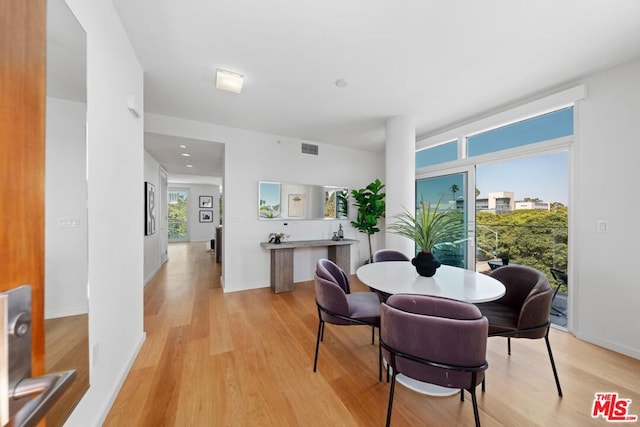 dining space with light hardwood / wood-style floors