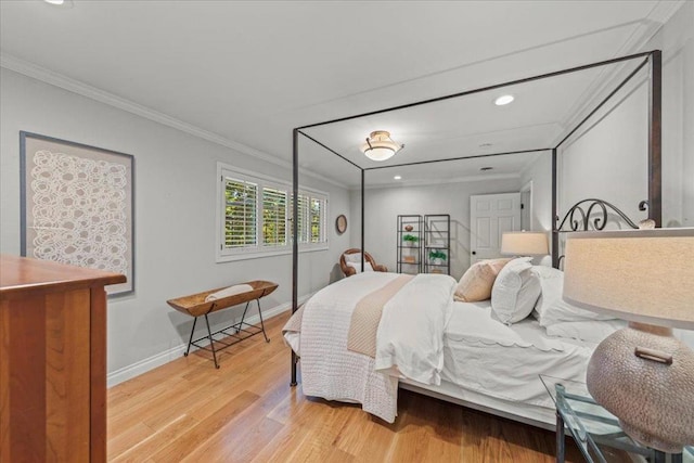 bedroom with ornamental molding and light hardwood / wood-style floors