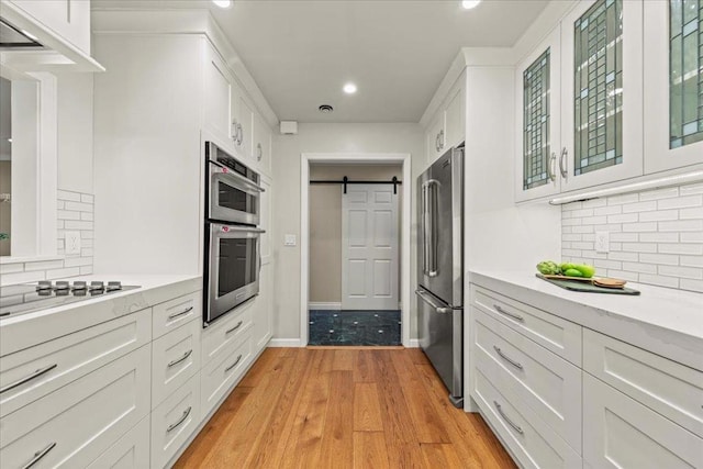 kitchen with white cabinetry and a barn door