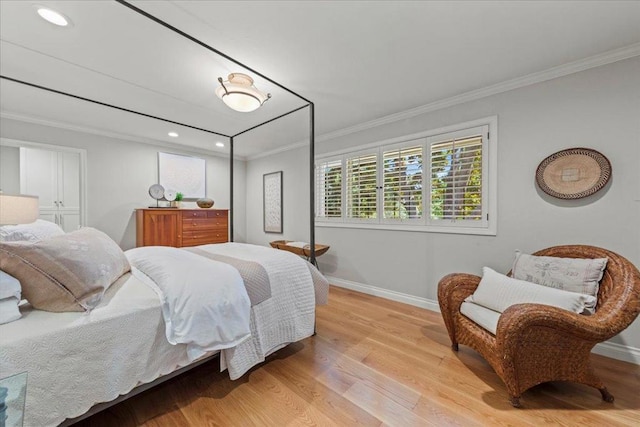 bedroom featuring ornamental molding and light wood-type flooring