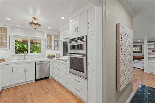 kitchen featuring white cabinetry, stainless steel appliances, and tasteful backsplash