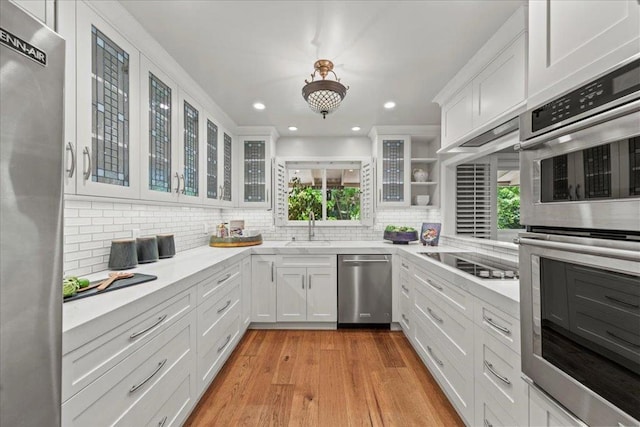 kitchen featuring white cabinetry, sink, tasteful backsplash, and stainless steel appliances