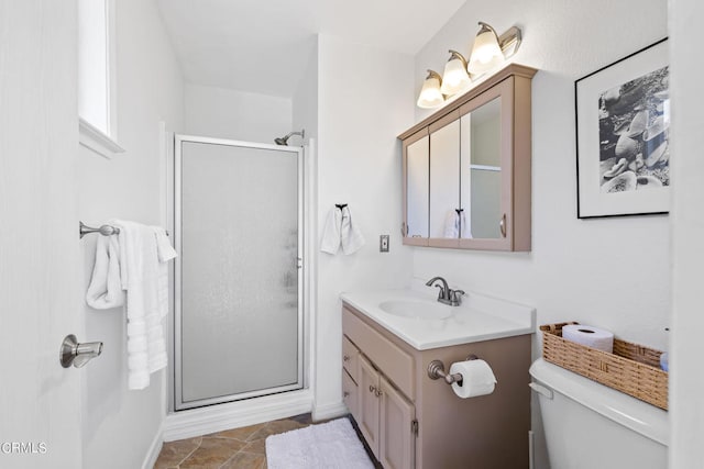 bathroom featuring vanity, an enclosed shower, and toilet