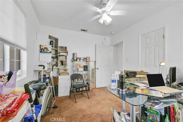 carpeted office featuring ceiling fan