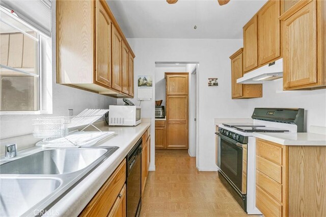 kitchen with black appliances, ceiling fan, sink, and light parquet floors