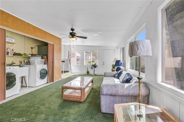 living room featuring carpet flooring, plenty of natural light, and washer / dryer