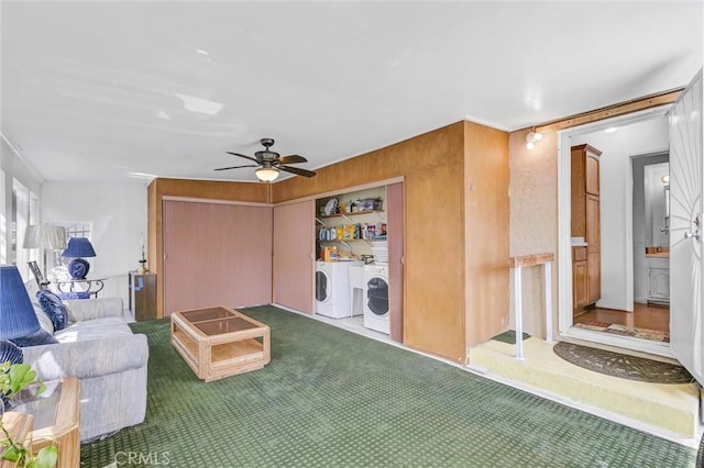 living room with separate washer and dryer, ceiling fan, and carpet