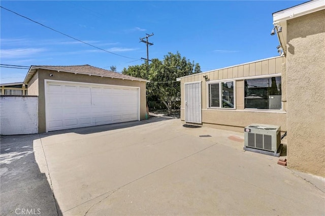 view of side of property featuring central air condition unit, an outdoor structure, and a garage