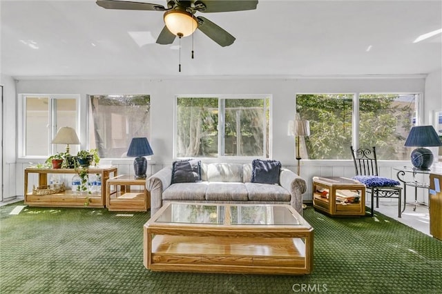 sunroom / solarium featuring ceiling fan and a healthy amount of sunlight