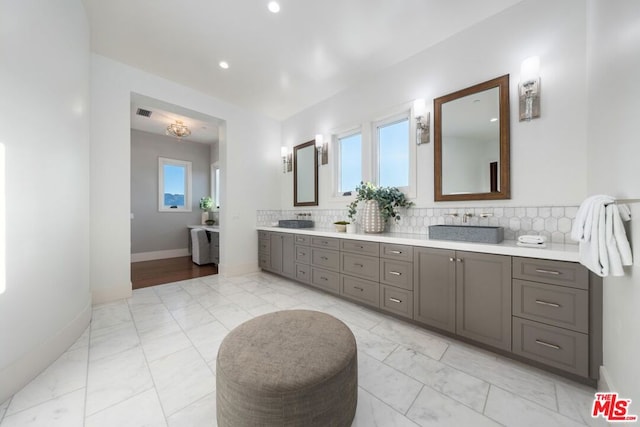 bathroom with vanity and decorative backsplash