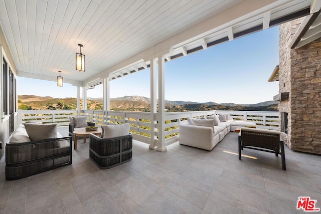 view of patio with outdoor lounge area and a mountain view