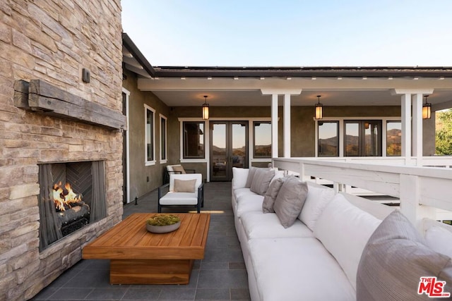 exterior space with an outdoor living space with a fireplace