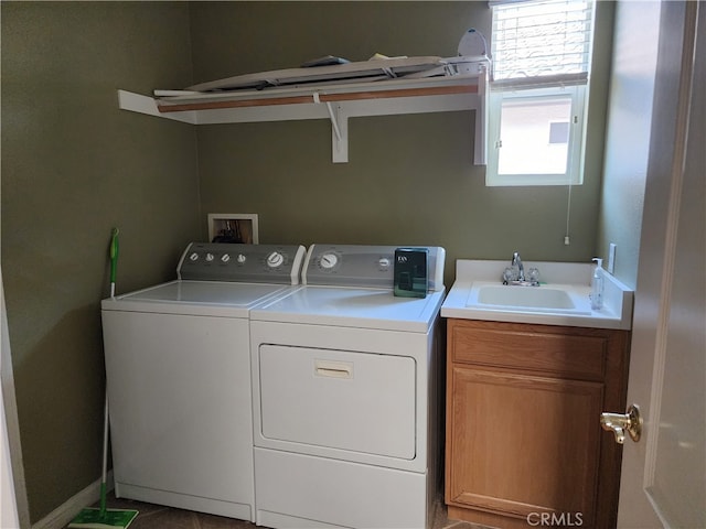 clothes washing area featuring cabinets, separate washer and dryer, and sink