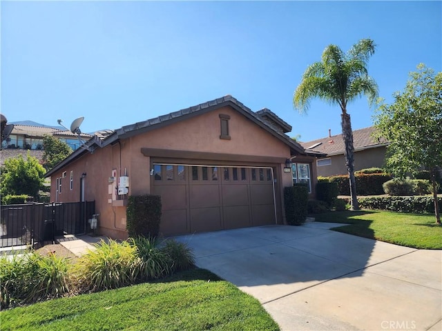 9153 Wooded Hill Dr, Corona, CA 92883 - view of side of home featuring fence, driveway, a yard, stucco siding, and a garage