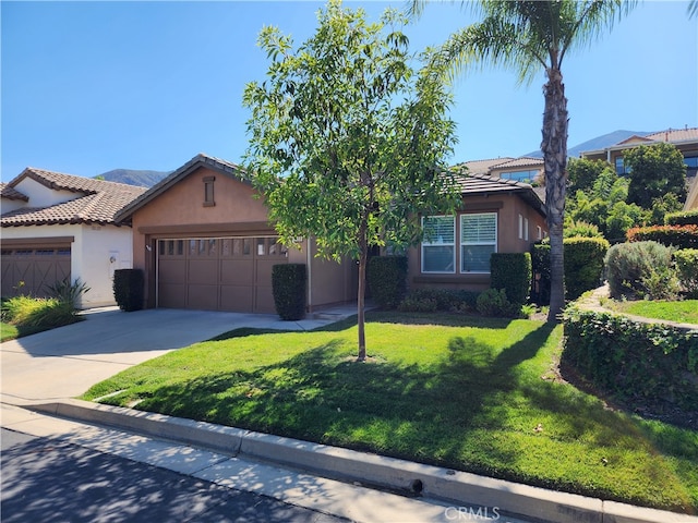 view of front of property with a garage and a front lawn