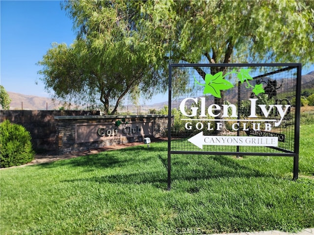 community sign with a lawn and a mountain view