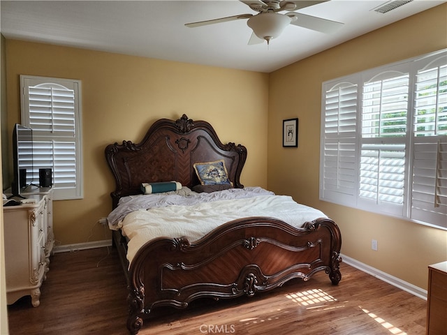 bedroom with ceiling fan and hardwood / wood-style flooring