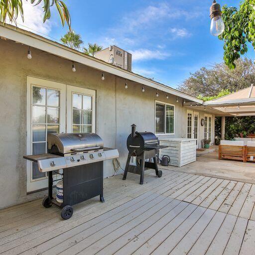 wooden deck with a grill