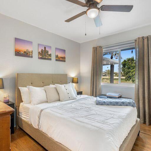 bedroom with ceiling fan and hardwood / wood-style floors