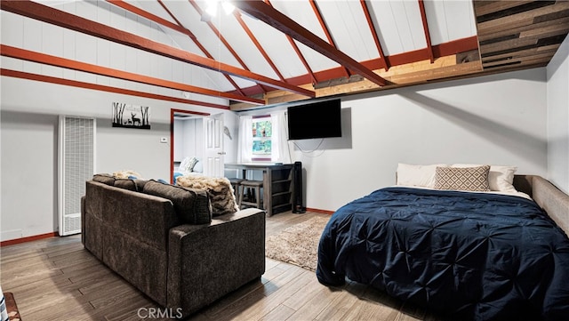 bedroom with hardwood / wood-style floors and high vaulted ceiling