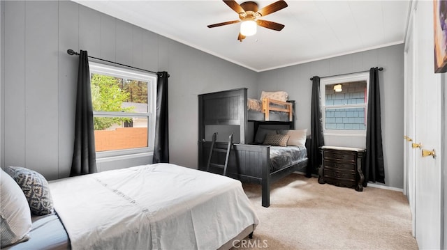 bedroom featuring ornamental molding, ceiling fan, and light colored carpet