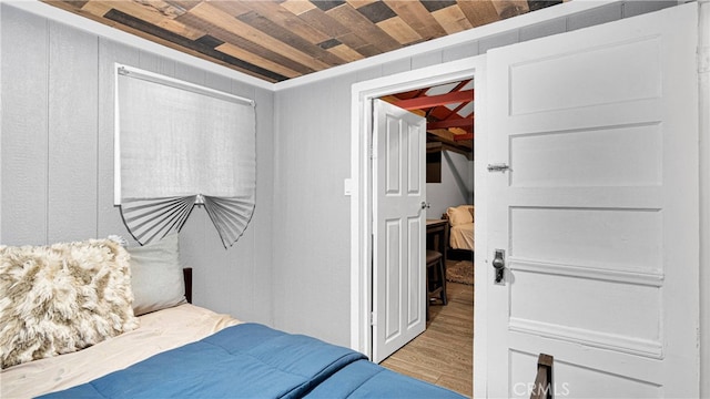 bedroom featuring wood walls, hardwood / wood-style flooring, and wooden ceiling