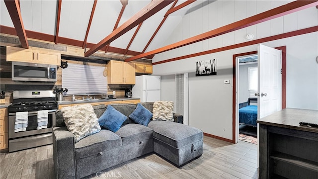 living room featuring light hardwood / wood-style flooring and high vaulted ceiling