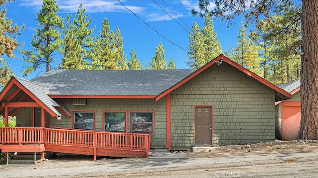 back of house with a wooden deck