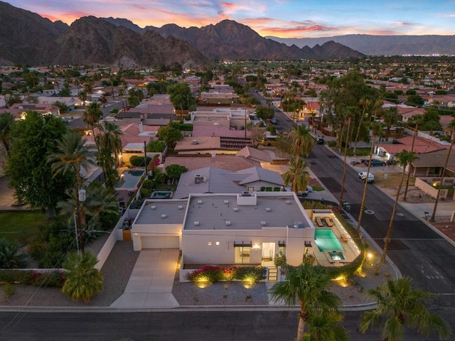 aerial view at dusk featuring a mountain view