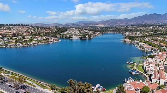 birds eye view of property featuring a water and mountain view