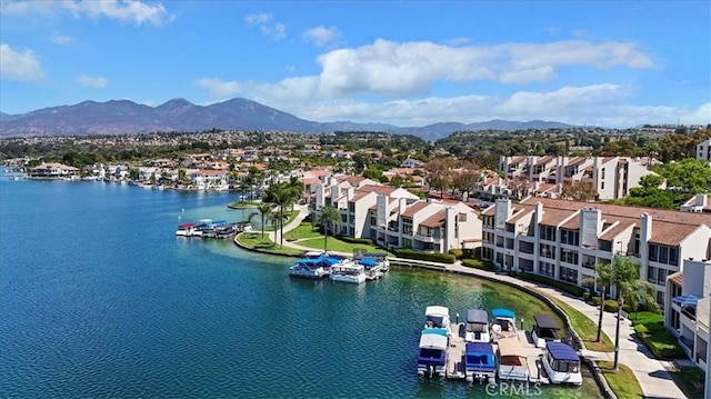 birds eye view of property featuring a water and mountain view